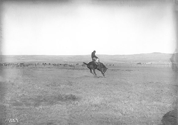 vintage photo of man on a bucking horse
