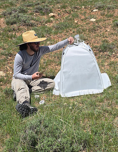 Man sits in prairie.