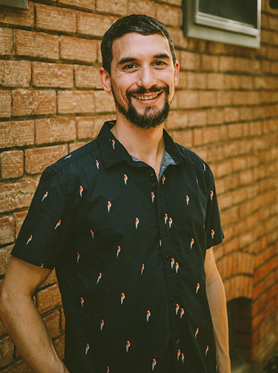 man standing by a wall