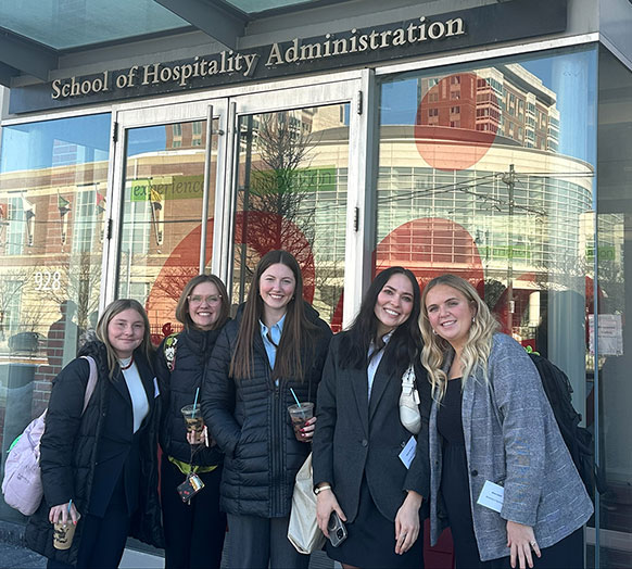group of people posing in front of a building