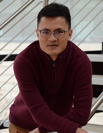 A man sits on a staircase.