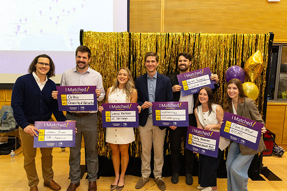 Students hold posters.