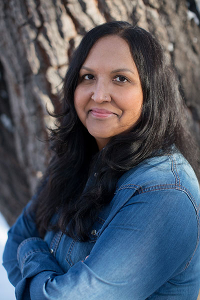 woman standing by a tree