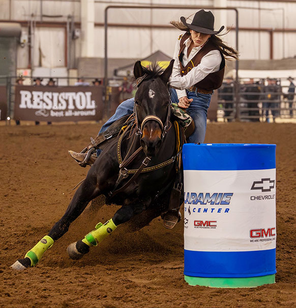 woman on horse rounding a barrel