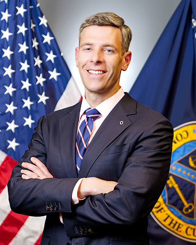 man posing in front of flags