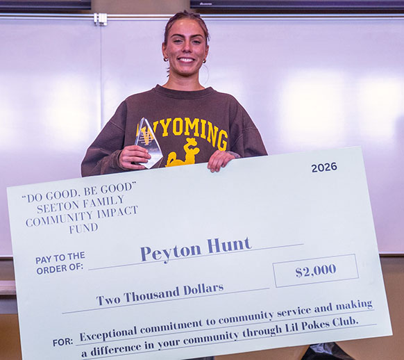 woman holding an oversized check