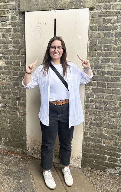 woman standing in front of a brick wall
