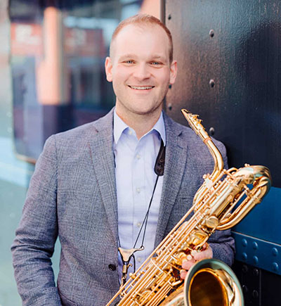 man holding a saxophone