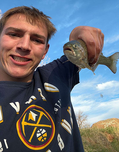 man holding up a fish