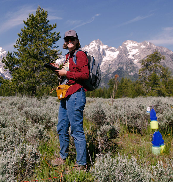 woman standing in a mountain meadow