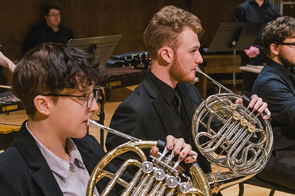 people playing French horns 