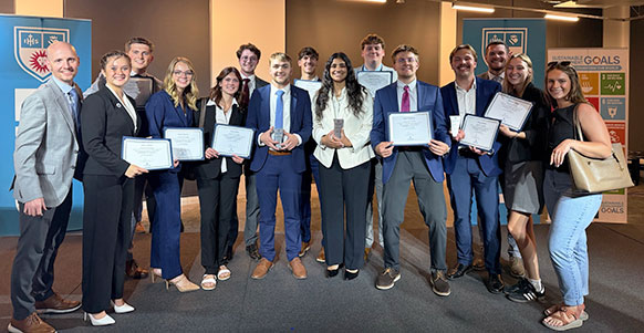 group of people posing with certificates