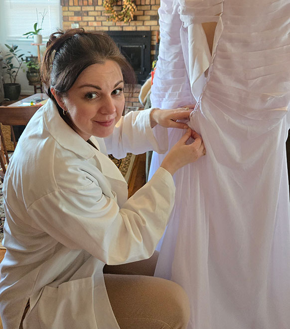 woman pinning a wedding dress