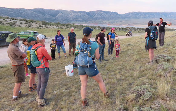 people gathered listening to someone on on the prairie