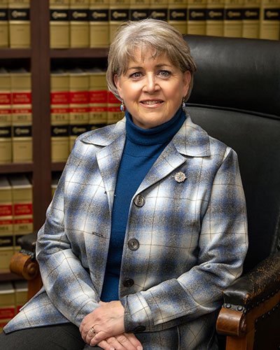 woman sitting in front of bookshelves