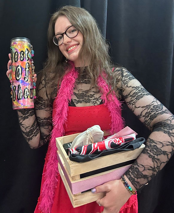 woman holding up an award