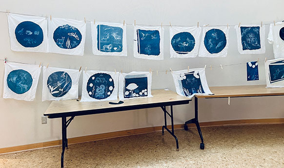 blue and white prints hanging from lines
