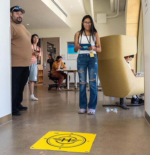 woman holding a tablet in a hallway