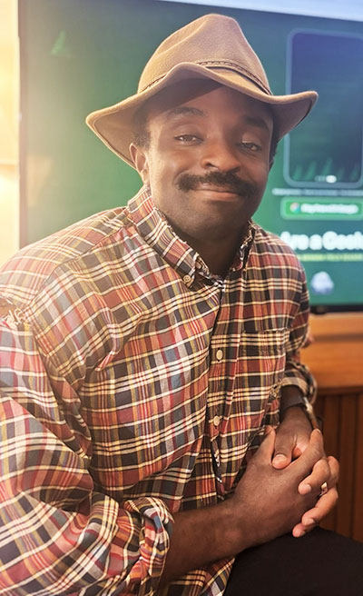 man leaning in front of a screen