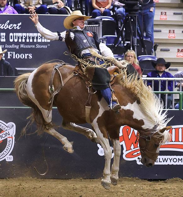 man riding a bucking horse