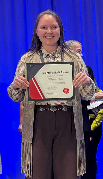 woman holding up award