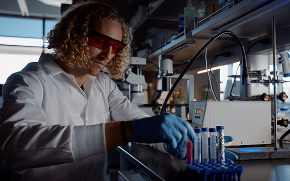 person working with test tubes in a lab