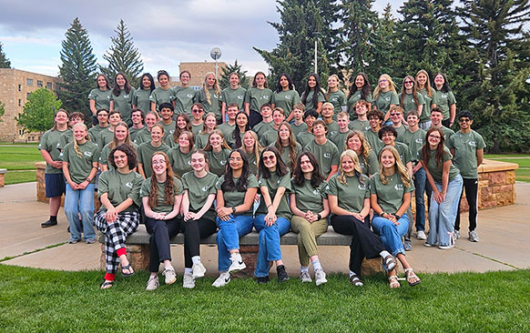 large group of people posing together outside