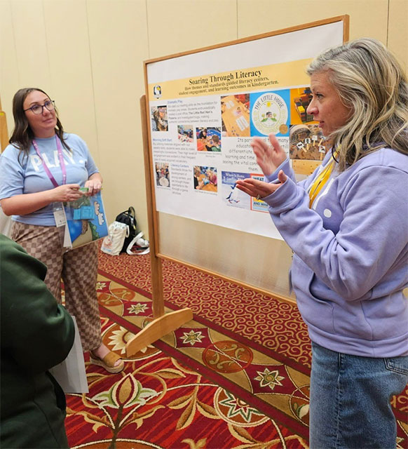 people talking beside a display board