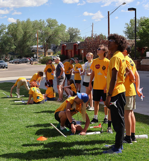 teenagers launching model rockets
