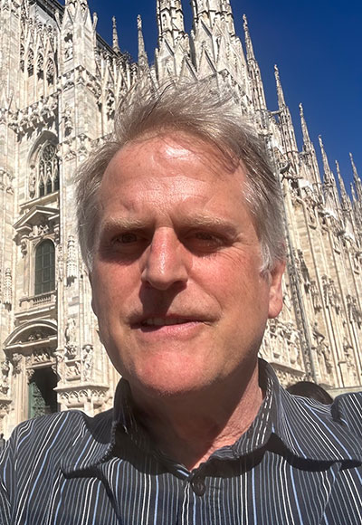 man standing in front of an elaborate building