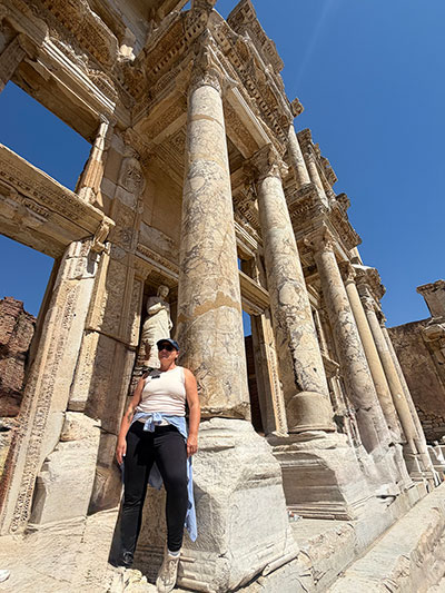 woman leaning against ancient ruins