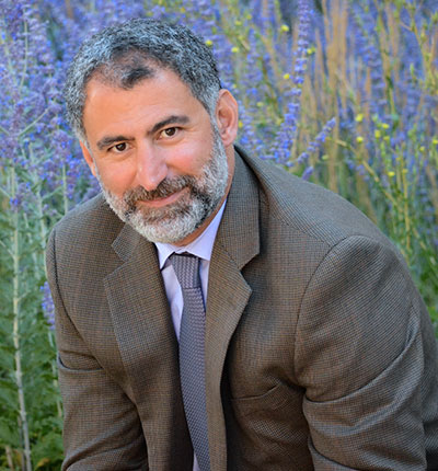 man in front of flowers