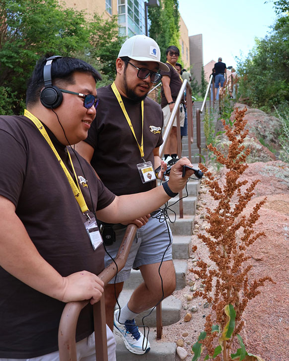 people holding devices to plants