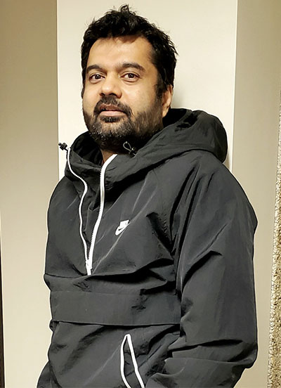 man leaning against a wall