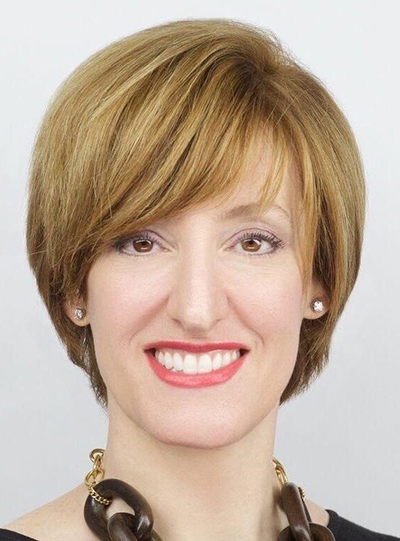 A woman smiles.