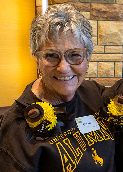 woman wearing Wyoming brown and gold