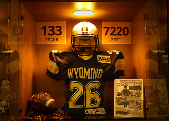 display case with football jersey and football memorabilia