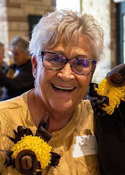 woman wearing Wyoming brown and gold