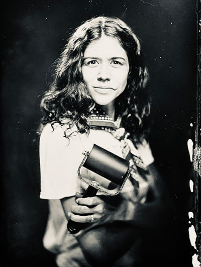 black and white photo of a woman holding an ink brayer