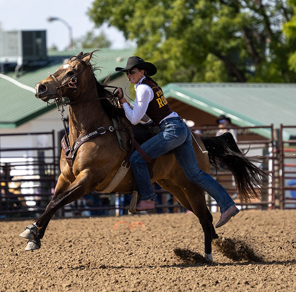 woman dismounting a running horse