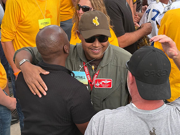 man greeting and hugging people in a crowd