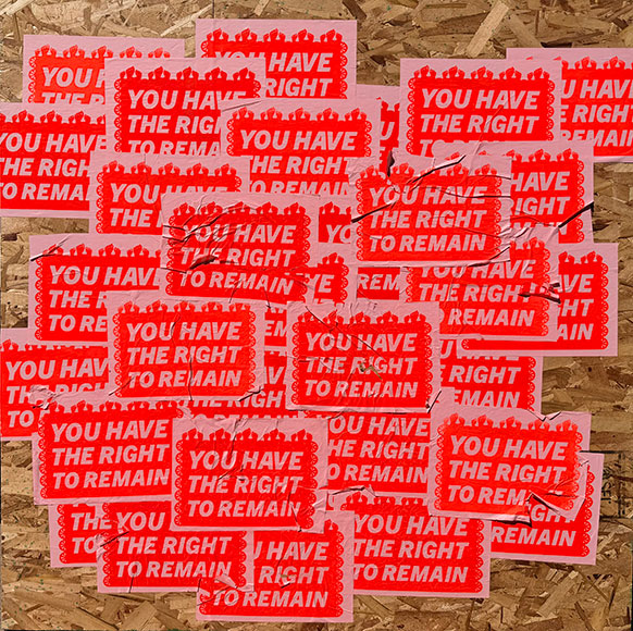 artwork with the words "you have the right to remain" in stickers all over it