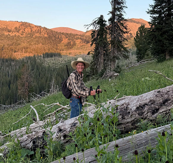 man hiking on a mountainside