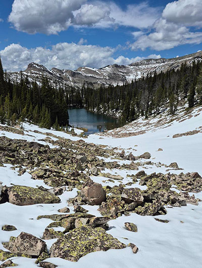 snowy landscape with lake and mountains