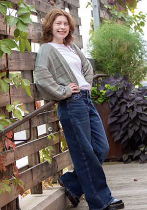 woman leaning against a fence