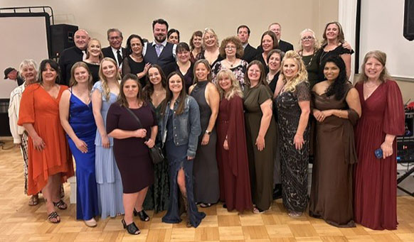 group of people in formal wear posing together