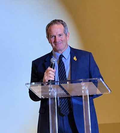 man with a microphone at a podium