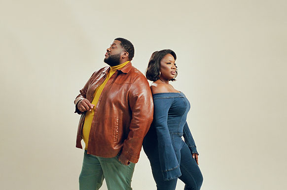 man and woman standing back to back