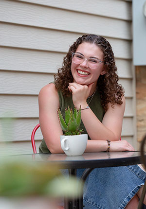 woman sitting at a table outside