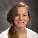 young woman with hair arranged to fall over her right shoulder